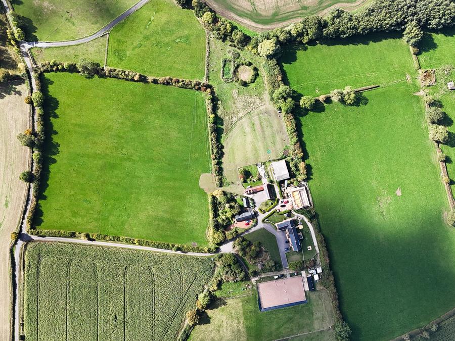 Straight-down view of a farmhouse set among hedged fields