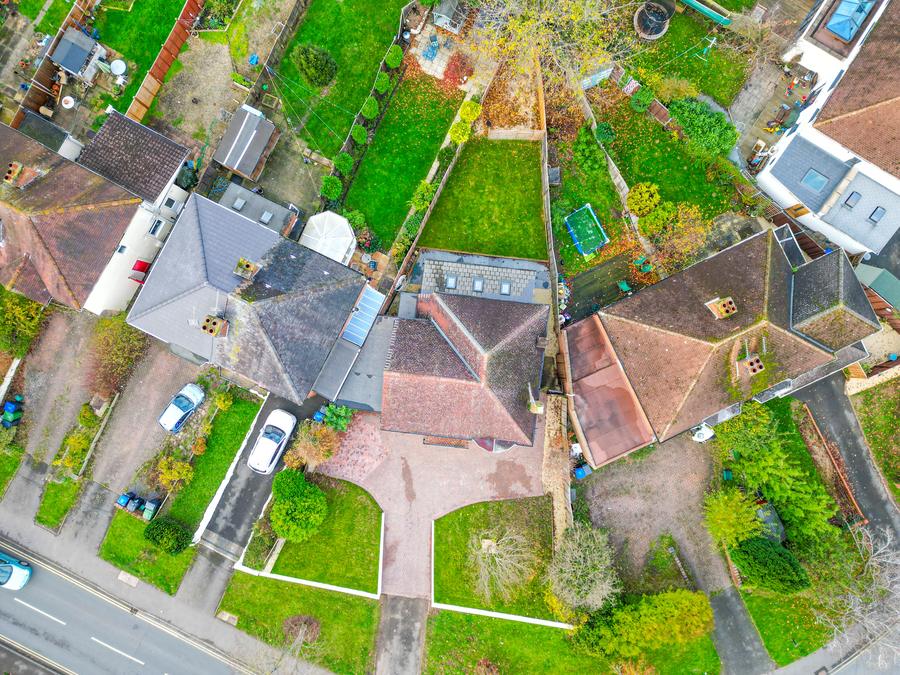Straight-down view of a suburban house, its drive and rear garden