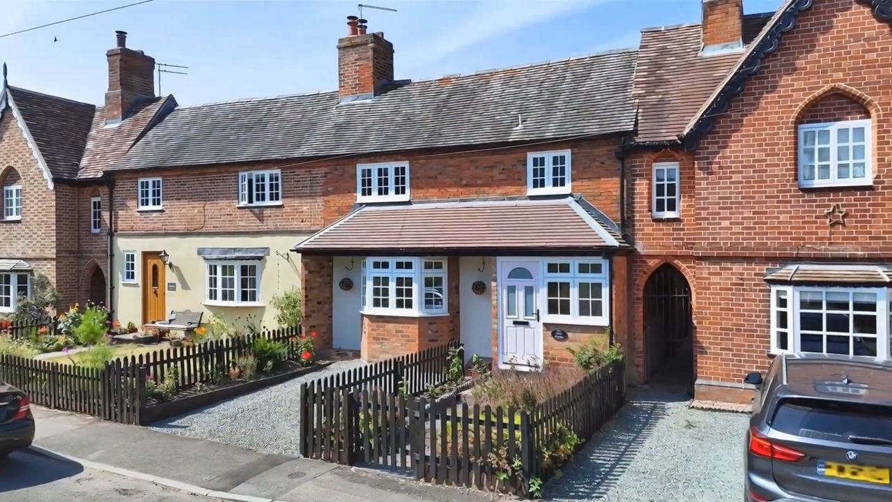 Rose Cottage: a terrace of brick and rendered cottages behind a low fence
