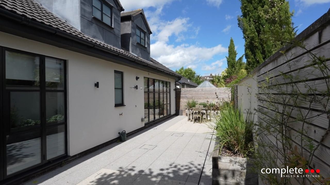 Conway Road: a rendered rear extension with folding doors onto a walled courtyard