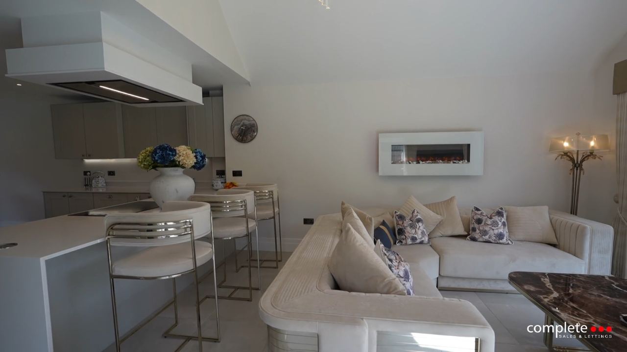Jephson Court: an open-plan living and kitchen space in white and pale timber