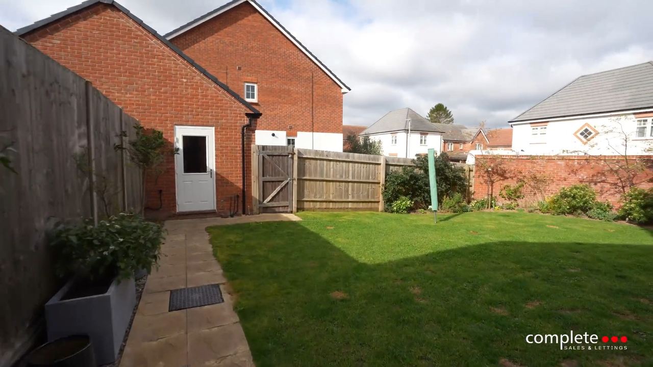 Hutchcocks Close: a lawned rear garden running back from the house