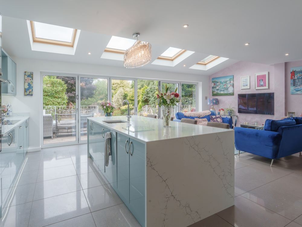 Open-plan kitchen and sitting room lit by three roof lanterns