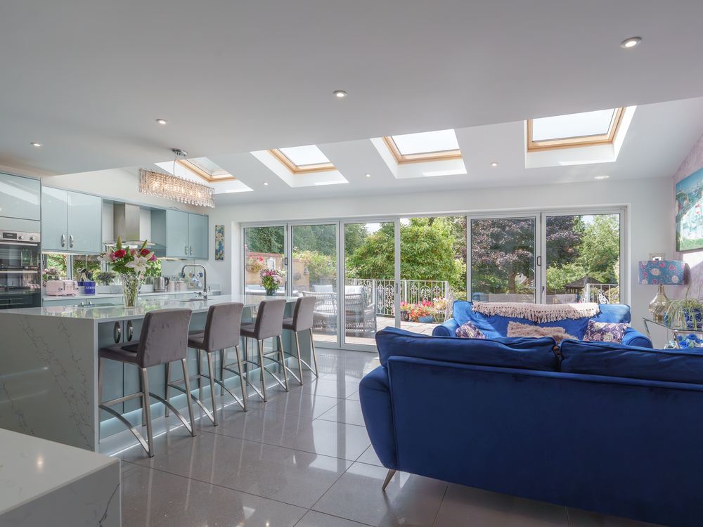 Kitchen looking through to the sitting area and garden doors
