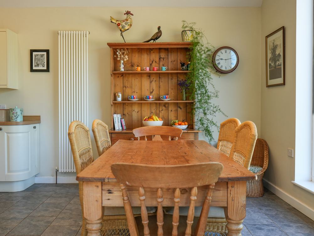 Dining room with a farmhouse table and a pine dresser
