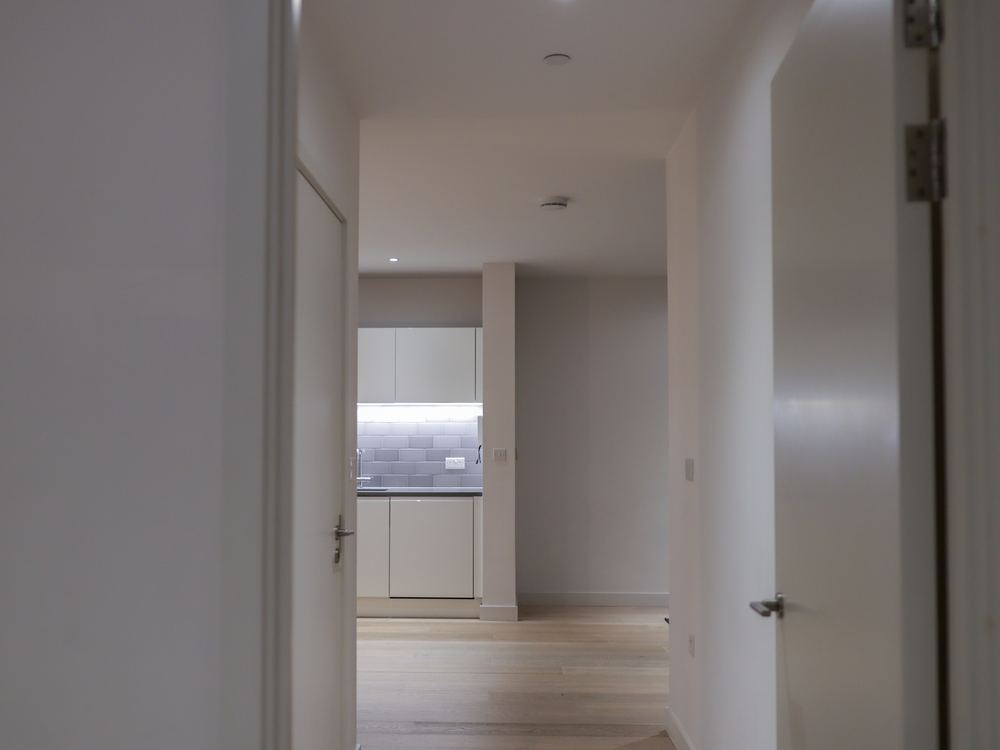 Hallway looking through an open door into a kitchen